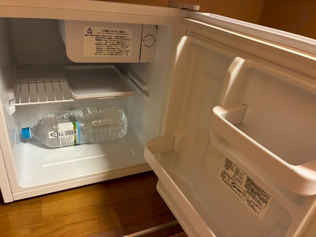 部屋の冷蔵庫。上は冷凍庫のタイプ。セイコーマートで購入した2Lの水も入りました。